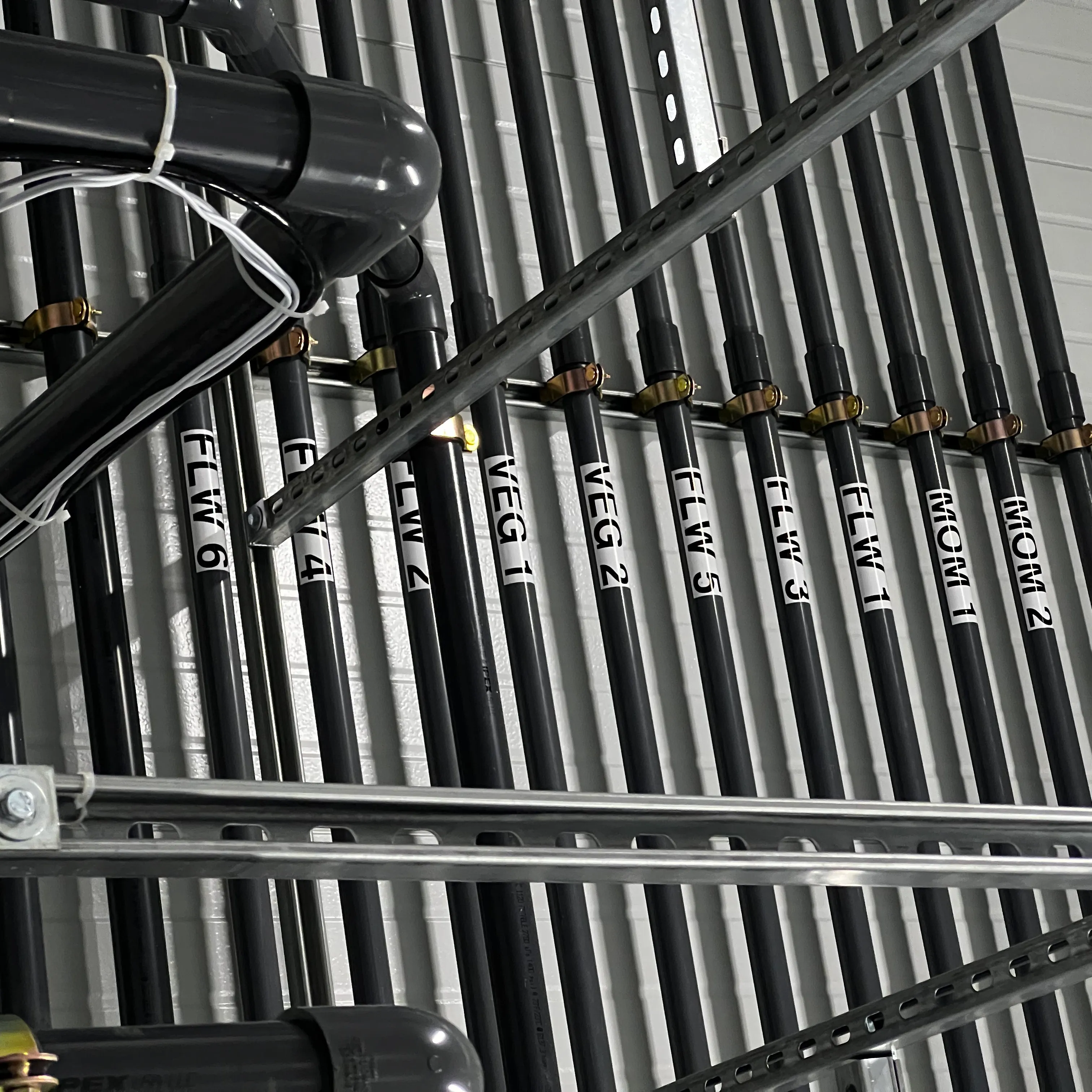 Labeled pipe runs on a rack.
