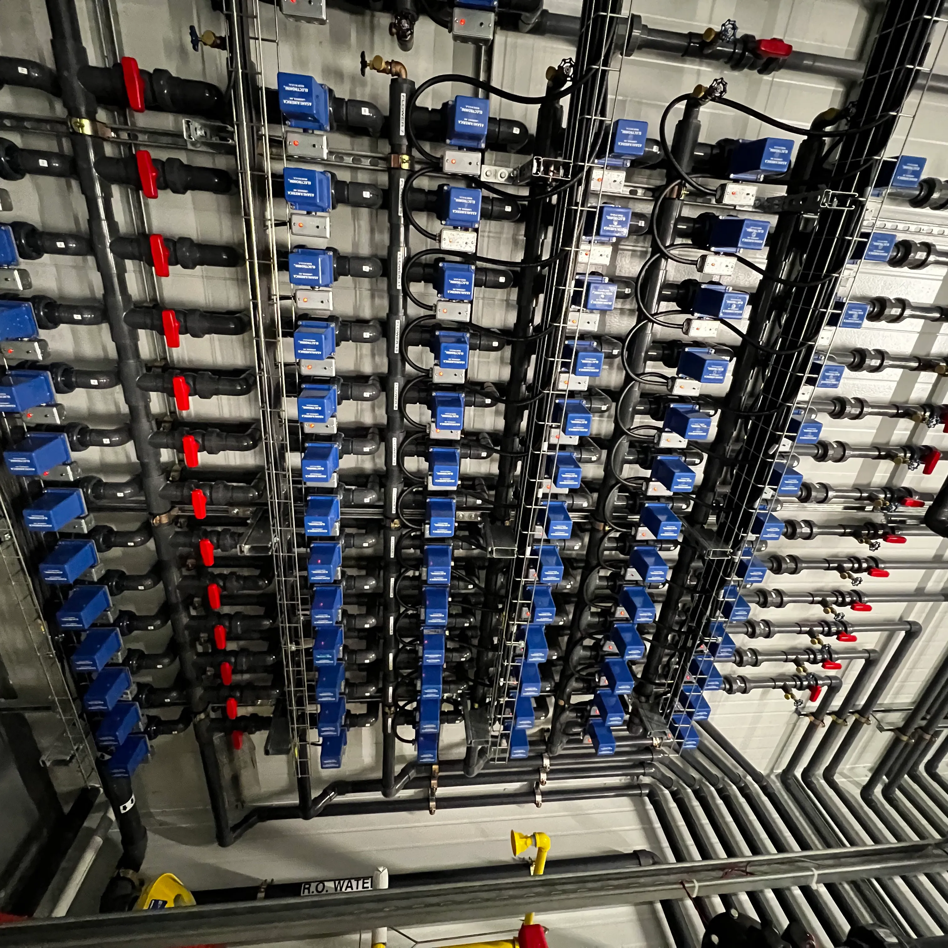 Rows of automated valve actuators on a manifold.