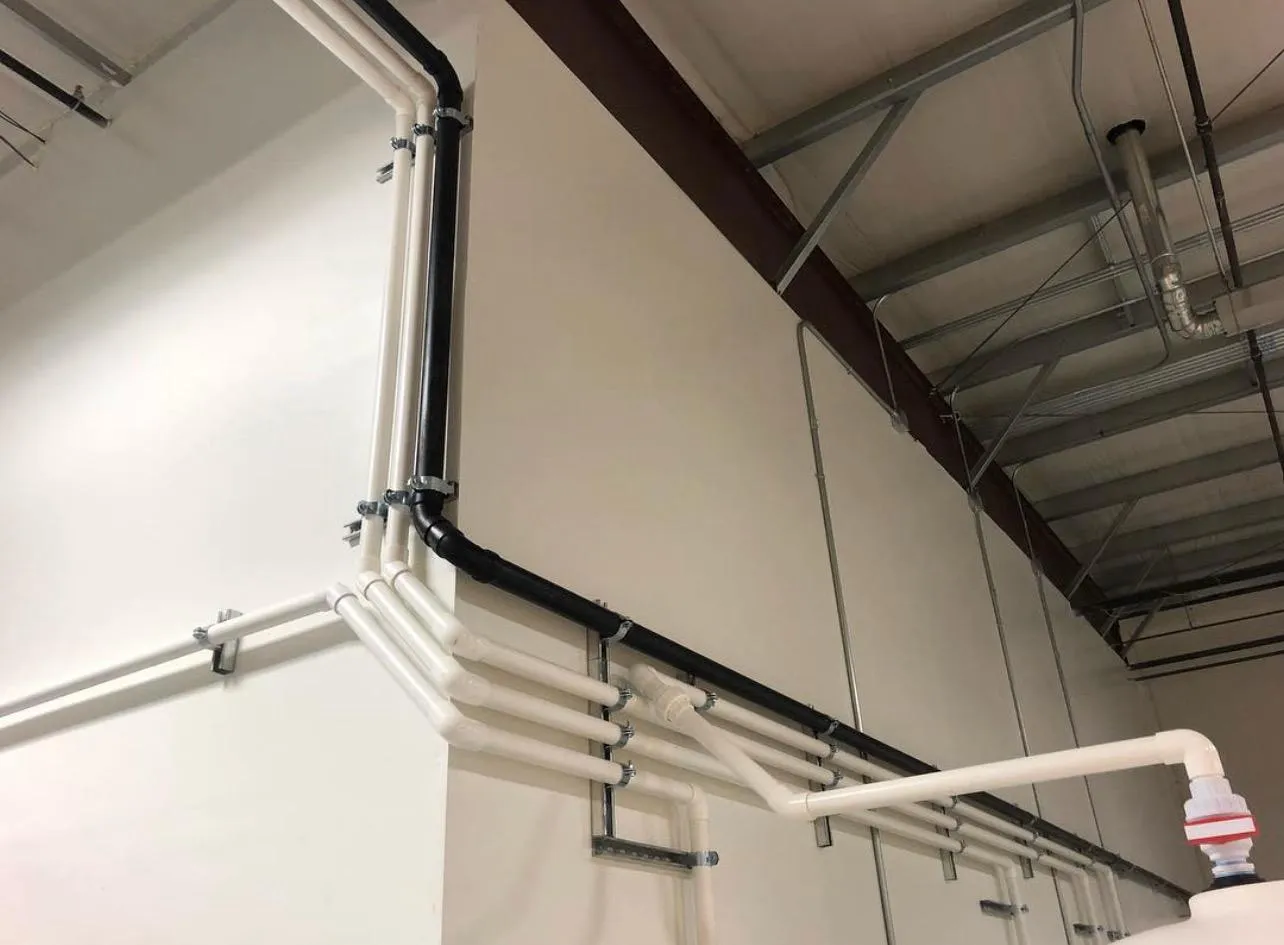Process pipe work along a facility wall.